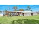 Rustic barn with covered area and equipment at 26225 Pitts Rd, Eustis, FL 32736