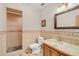 Bathroom with granite countertop, wood cabinet, and walk-in shower at 26225 Pitts Rd, Eustis, FL 32736