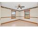Bedroom with ceiling fan and wood-trimmed windows at 26225 Pitts Rd, Eustis, FL 32736
