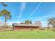 Ranch style home with metal roof, large porch, and fenced yard at 26225 Pitts Rd, Eustis, FL 32736