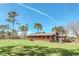 Ranch style home with metal roof, large porch, and fenced yard at 26225 Pitts Rd, Eustis, FL 32736