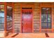 Red front door on a rustic wood home at 26225 Pitts Rd, Eustis, FL 32736