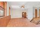 Spacious Gathering room with terracotta tile floors and wood-paneled walls at 26225 Pitts Rd, Eustis, FL 32736