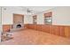 Rustic Gathering room featuring a brick fireplace, wood paneling, and terracotta tile floors at 26225 Pitts Rd, Eustis, FL 32736