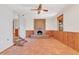 Rustic Gathering room with a brick fireplace, wood paneling, and terracotta tile floors at 26225 Pitts Rd, Eustis, FL 32736