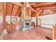 Living room with a large stone fireplace and wood beamed ceiling at 26225 Pitts Rd, Eustis, FL 32736