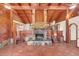Living room with a large stone fireplace and wood ceiling at 26225 Pitts Rd, Eustis, FL 32736
