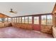 Bright sunroom with tile floors and wooden walls at 26225 Pitts Rd, Eustis, FL 32736