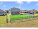 House with gray roof and artificial turf backyard at 275 Sunfish Dr, Winter Haven, FL 33881