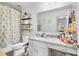 Clean bathroom with granite countertop, shower/tub combo, and decorative shelving at 275 Sunfish Dr, Winter Haven, FL 33881