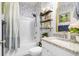 Charming bathroom with a shower/tub combo, granite countertop, and blue floral wallpaper at 275 Sunfish Dr, Winter Haven, FL 33881