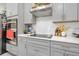 Sleek kitchen with gray cabinets, white hex tile backsplash, and gas cooktop at 275 Sunfish Dr, Winter Haven, FL 33881