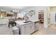 Open concept kitchen with island, white cabinets, and pantry at 275 Sunfish Dr, Winter Haven, FL 33881