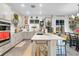 Island kitchen with white cabinets, quartz countertops and stainless steel appliances at 275 Sunfish Dr, Winter Haven, FL 33881