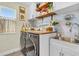 Laundry room with modern washer and dryer, wood shelves, and a utility sink at 275 Sunfish Dr, Winter Haven, FL 33881
