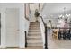 Modern carpeted staircase with a view into the kitchen and dining area at 275 Sunfish Dr, Winter Haven, FL 33881