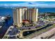 Aerial view of a luxury waterfront condo building with parking and a pond at 2801 S Ridgewood Ave # 807, South Daytona, FL 32119