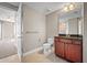 Bathroom with granite vanity, dark wood cabinets and a toilet at 2801 S Ridgewood Ave # 807, South Daytona, FL 32119
