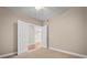Condo bedroom with hardwood floors and access to another room at 2801 S Ridgewood Ave # 807, South Daytona, FL 32119