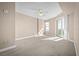 Bright bedroom with carpet flooring, ceiling fan, and sliding glass doors leading to a balcony at 2801 S Ridgewood Ave # 807, South Daytona, FL 32119