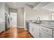 Modern kitchen with white cabinets, granite counters, and stainless steel appliances at 2801 S Ridgewood Ave # 807, South Daytona, FL 32119