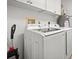 Laundry room with Samsung washer and dryer, and ample overhead cabinets at 2801 S Ridgewood Ave # 807, South Daytona, FL 32119