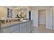 Elegant bathroom with granite countertop, double sinks and linen closet at 33463 Copper Hill Way, Sorrento, FL 32776