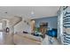 Open living room with light beige couch, blue arm chair, and staircase at 33463 Copper Hill Way, Sorrento, FL 32776