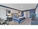 Main bedroom with a king bed, two nightstands and ensuite bathroom at 33463 Copper Hill Way, Sorrento, FL 32776
