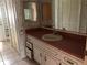 Bathroom vanity with sink and drawers, and patterned wallpaper at 34847 Learn Rd, Leesburg, FL 34788