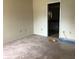 Carpeted bedroom with access to bathroom at 34847 Learn Rd, Leesburg, FL 34788