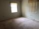 Empty bedroom featuring carpeted floors and window at 34847 Learn Rd, Leesburg, FL 34788
