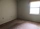 Simple bedroom with carpeted floors and a window at 34847 Learn Rd, Leesburg, FL 34788