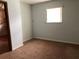 Simple bedroom with a single window and carpeted floors at 34847 Learn Rd, Leesburg, FL 34788