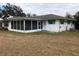 Rear view of a home with a screened porch at 34847 Learn Rd, Leesburg, FL 34788