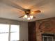Living room with brick fireplace and ceiling fan at 34847 Learn Rd, Leesburg, FL 34788