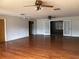 Large living room with hardwood floors and ceiling fans at 34847 Learn Rd, Leesburg, FL 34788