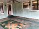 Screened porch with ceiling fan and worn flooring at 34847 Learn Rd, Leesburg, FL 34788
