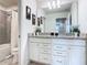 Bathroom with double vanity, granite countertop, and white cabinets at 3798 Lana Ave, Davenport, FL 33897