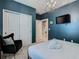 Bedroom with dark-blue walls, a queen bed, and an en-suite bathroom at 3798 Lana Ave, Davenport, FL 33897