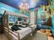 Twin beds in a whimsical bedroom with a mural at 3798 Lana Ave, Davenport, FL 33897