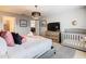 Bright bedroom with a king-size bed, crib, and dresser at 3798 Lana Ave, Davenport, FL 33897