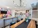 Open concept dining room with a long wood table and modern chandelier at 3798 Lana Ave, Davenport, FL 33897