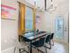 Dining area with a wood table, black chairs, and modern chandelier at 3798 Lana Ave, Davenport, FL 33897