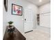 Bright entryway with tile flooring, coat bench, and modern decor at 3798 Lana Ave, Davenport, FL 33897