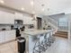 Open kitchen with granite island, white cabinets, and stainless steel appliances at 3798 Lana Ave, Davenport, FL 33897