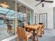 Covered patio with wooden table and chairs, perfect for outdoor dining at 3798 Lana Ave, Davenport, FL 33897