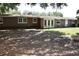 Back exterior of the house showing a large yard and double doors that lead inside at 423 Longfellow Blvd, Lakeland, FL 33801