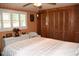 Cozy bedroom features tiled floors, neutral decor, and comfortable queen bed at 423 Longfellow Blvd, Lakeland, FL 33801