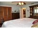 Bedroom includes a queen-sized bed, hardwood floors and closet with louvered doors at 423 Longfellow Blvd, Lakeland, FL 33801